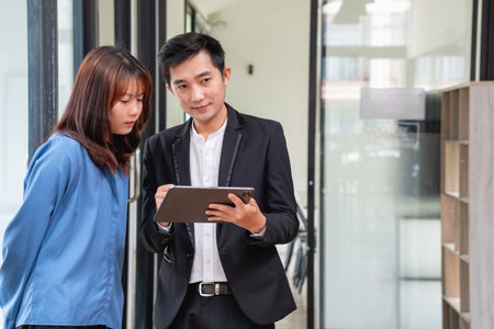 They are working, thinking, and planning on the tablet of a business team developing a project. The technology marketing group works with web research. Office workers are looking at tablets together.の写真素材