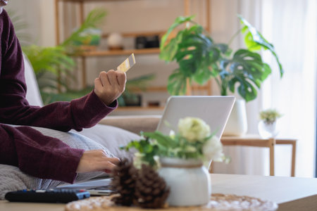 Beautiful Asian women using credit cards for shopping online with laptops and smartphones, online shopping portrait concept.の写真素材