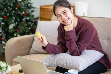 Beautiful Asian women using credit cards for shopping online with laptops and smartphones, online shopping portrait concept.の写真素材