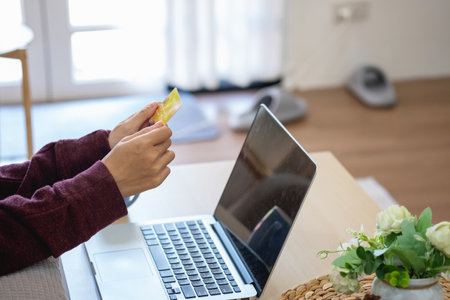 Beautiful Asian women using credit cards for shopping online with laptops and smartphones, online shopping portrait concept.の写真素材
