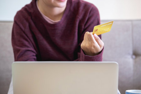 Beautiful Asian women using credit cards for shopping online with laptops and smartphones, online shopping portrait concept.の写真素材