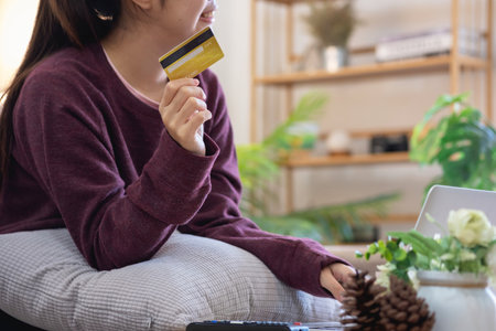 Beautiful Asian women using credit cards for shopping online with laptops and smartphones, online shopping portrait concept.の写真素材