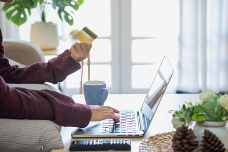Beautiful Asian women using credit cards for shopping online with laptops and smartphones, online shopping portrait concept.の写真素材