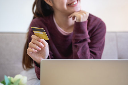 Beautiful Asian women using credit cards for shopping online with laptops and smartphones, online shopping portrait concept.の写真素材