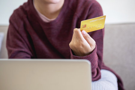 Beautiful Asian women using credit cards for shopping online with laptops and smartphones, online shopping portrait concept.の写真素材