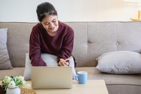 Beautiful Asian women using credit cards for shopping online with laptops and smartphones, online shopping portrait concept.の写真素材