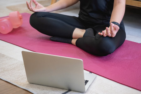 Healthy young woman doing breathing exercises at home, beautiful woman meditating at home with eyes closed, practicing yoga, doing pranayama techniques Mindfulness meditation conceptの写真素材