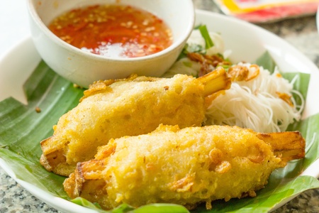 Fried shrimp on sugar cane and sauce の写真素材