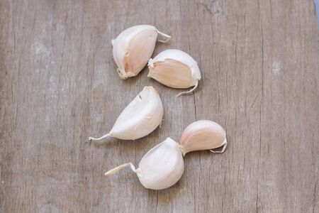 Garlics on wood surface の写真素材