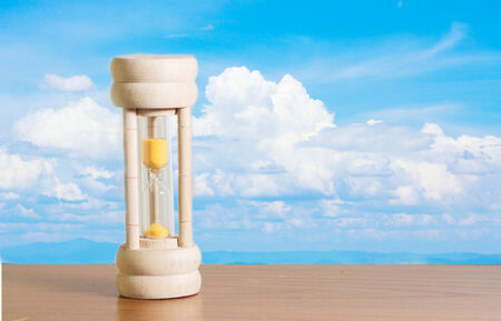 Hourglass with sky background の写真素材