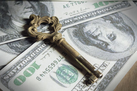 Antique key on money の写真素材