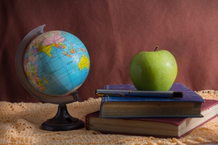 Still life globe and apple with stationary の写真素材