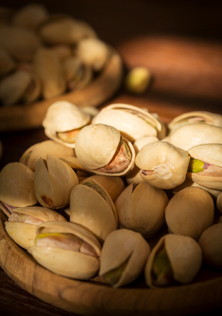 Pistachios nut in wood plate,still life の写真素材