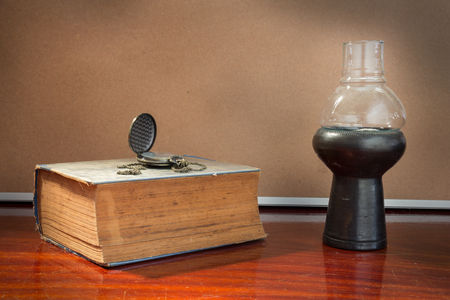 Still life Antique book and watch with lamp.の写真素材