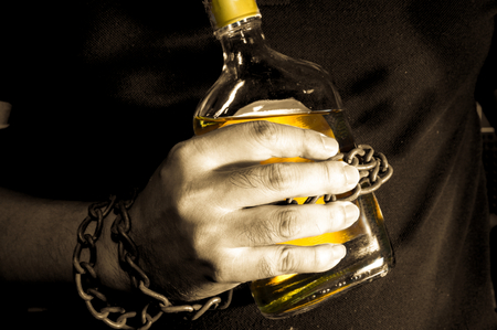 Sepia tone filtered slave to alcoholの写真素材