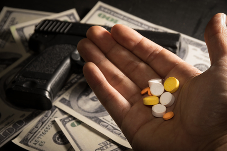 Drug pills in hand,crime concept.の写真素材