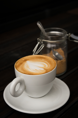 Hot cappuccino coffee with brown sugar,still lifeの写真素材