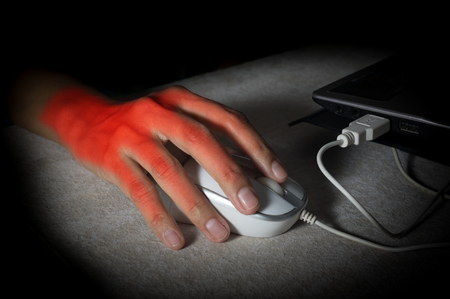 Female hand got pain from using mouse.の写真素材