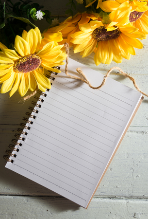 Book with sun flowers on wood table.の写真素材