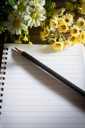 Pencil and book with flowers,still life.の写真素材