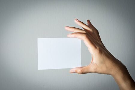 Woman hand holding paper.の写真素材
