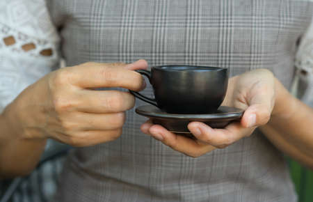 Coffee cup in woman hand,food and drink.の写真素材