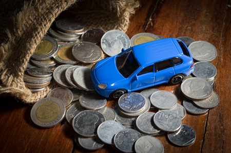 Blue Toy car with money and sack.の写真素材