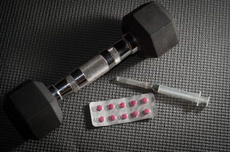 Dumbbell with drug pack and syringe.の写真素材