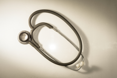 Old and rusty stethoscope on table,vintage filtered.の写真素材