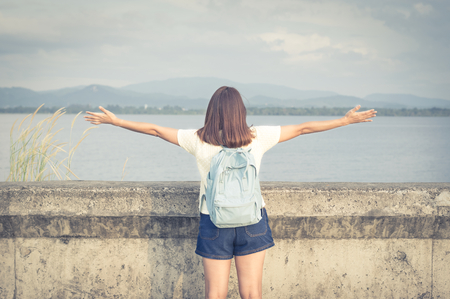 Woman extend her arm at lake.の写真素材