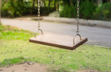 Wooden old swings in playgroundの写真素材