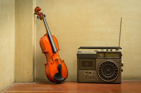 Wooden violin with old style radio,still life.の写真素材