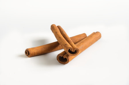 Cinnamon sticks aromatic condiment on white background.の写真素材