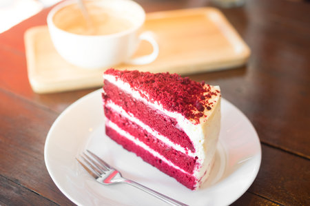 A piece of red velvet cake with coffee cup.の写真素材
