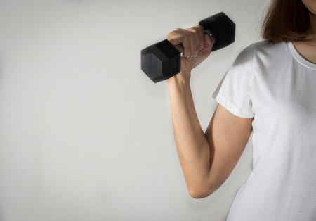 Woman workout with metal dumbbell.の写真素材
