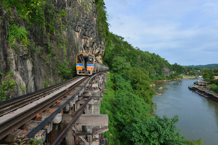 The railway along with the cliff and  the small tributary kwai noi riverの写真素材