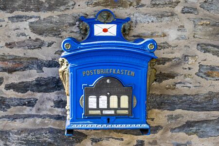 German old blue post box hanging on a brick wallの写真素材