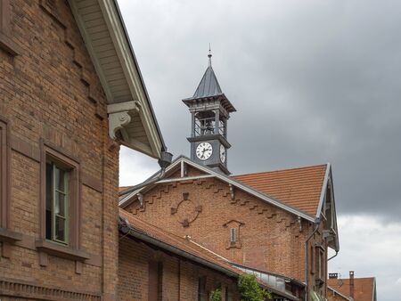 Clock tower on an old red brick houseの写真素材