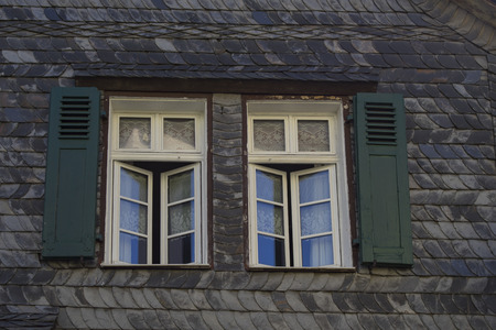 Slate-clad wall with two windows in the Hunsrueck mountains. Herrstein City Germany
