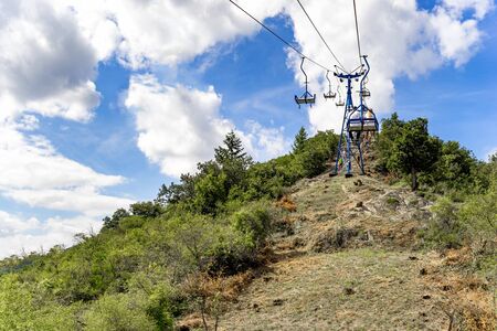 Chairlift on a sunny day and blue skyの写真素材