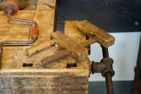 Old woodwork bench on which is a wooden screw clampの写真素材
