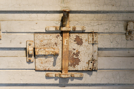 Closed iron window at an old prison doorの写真素材