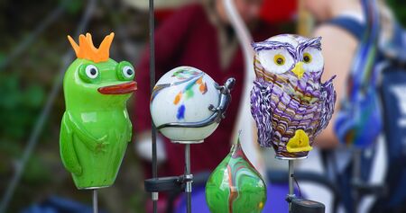 Owl, frog and lizard, made of glass, waiting for buyers at a marketの写真素材