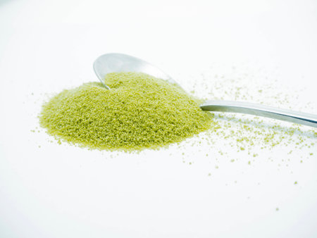 Green Tea in silver spoon shaped like a heartの写真素材