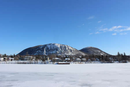 Mont-St-Hilaire, Quebec in winter with the mountain and the church from across the Richelieu Riverの写真素材