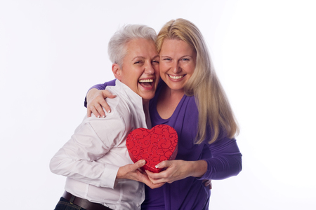 Mother and daughter holding a present in there handsの写真素材
