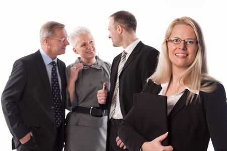 Blonde Business Woman with her team in the backgroundの写真素材