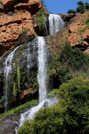 Waterfall tumbles over the rocks in the forestの写真素材