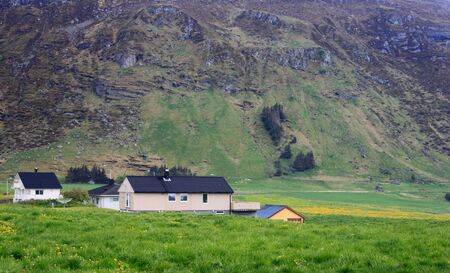 Travel - farmstead below a cliff in Alesund, Norwayのeditorial素材