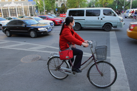 People of China  lady with pollution mask on bicycleのeditorial素材